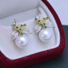 Our 11-12mm Freshwater Pearl & Color Floral Earrings are the perfect way to show off your unique style. The glimmering pearls and vibrant flower design will instantly add charm to any look. Exuding elegance, these earrings are perfect for any occasion, formal or casual. Crafted by House of Pearls, these earrings are sure to become your favorite go-to accessory. Make a timeless statement with every wear and step out with confidence! Pearl size:Earrings: 11-12mm This popular earrings design featur Elegant Green Round Flower Earrings, Elegant Green Pearl Earrings Gift, Elegant White Flower Earrings With Pearl Charm, Elegant White Round Flower Earrings, Elegant White Floral Earrings, Elegant Green Pearl Earrings For Pierced Ears, Elegant Pearl White Flower-shaped Earrings, Elegant Green Flower Earrings, Elegant Green Pearl Charm Earrings