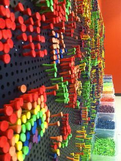 there are many different colored pins on the pegboard