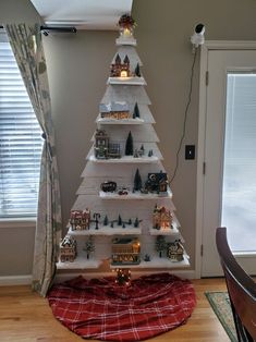 a christmas tree made out of bookshelves in the corner of a living room