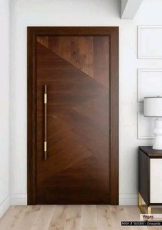 a modern wooden door in the corner of a room with white walls and wood flooring