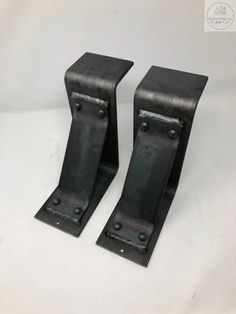 two black metal brackets on a white background