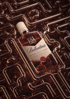 a bottle of ballantine's whiskey sitting on top of a metal surface