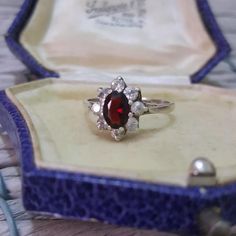 Beautiful sterling silver vintage ring, 11mm at front, beautiful Retro floral design with a halo of simulated diamonds and a genuine red garnet gemstone in the middle, most alluring sparkle Full UK Hallmarked, dated 1986, in very good condition Size Q US 6.25 Weight 2.4gr All gemstones have been fully tested All silver has been fully verified Jewellery box is for presentation purposes only Floral Ring, Garnet Gemstone, Retro Floral, Vintage Ring, Red Garnet, Design Floral, Rings Statement, 925 Sterling Silver Ring, Sterling Silver Ring