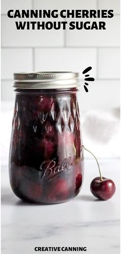 a jar filled with cherries sitting on top of a counter