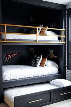 the bunk bed is built into the wall and has two drawers underneath it, along with pillows