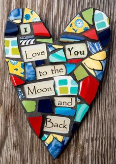 a mosaic heart with words on it that say i love you to the moon and back