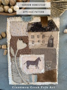 an applique quilt with a horse on it next to some nuts and other things