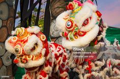 two colorful lion costumes are standing next to each other