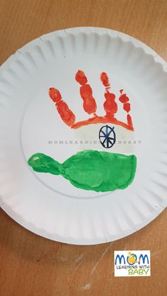 a paper plate that has a handprint on it