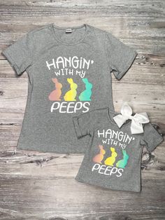 We know you've been peeping at all of our mom and me tees! So of course we had to bring all of our mom and me duos our Hanging With My Peeps T-Shirt! The adorable gray tee includes the phrase: "hanging with my peeps" and colorful bunny details. These adorable tees are staple in you and your little one's Easter/spring wardrobe! The shirts are super easy to pair with jeans, leggings, sweatpants, and so much more. You can wear these tops to school, work, running errands, Easter festivities, and so Cricut Corner, Bunny Peeps, Holidays Decorations, Easter Festivities, Cricut Decals, Easter Board, Music Ministry, Cricket Ideas