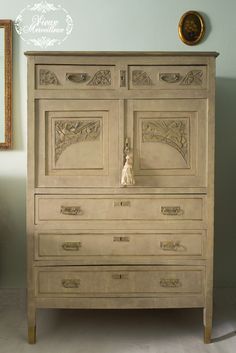 an old dresser with ornate carvings on the doors and drawers is shown in this photo