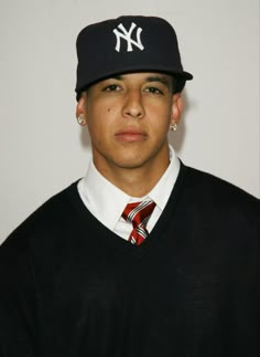 a young man wearing a new york yankees hat