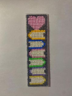 a bookmark made out of beads with the word love spelled in different colors and shapes