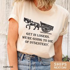 The Boho Boutiques Award-Winning Get In Losers We're Going to Die of Dysentery t-shirt is perfect for any occasion. Our handcrafted History teacher tee,history teacher gift,history,historylover,history gifts,american history,historian shirt,historian tee,historian gifts,social studies,history tshirt,history shirt,funny historian gift designs are printed on the softest material with the highest quality eco-friendly ink available! We believe in only selling items using ink that is not only safe fo Funny History Shirts, Historian Gifts, History Teacher Aesthetic, History Tshirts, History Teacher Gifts, Funny History, Silly Shirt, History Teacher, Social Studies Teacher