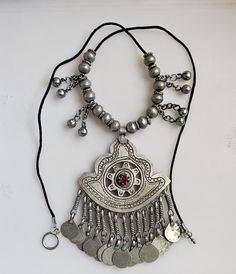 This listing is for a gorgeous Afghan Kashmiri pendant, charms and beads necklace.  The pendant measures 3 inches wide by 4.75 inches long including bail.  The necklace measures about 28 inches long. Item# SP1907-490 The pendant and beads are vintage so minor imperfections are to be expected. Kashmiri Jewellery, Accessory Inspo, Ethnic Necklaces, Designer Outfits, Indian Designer Outfits, Indian Designer, Ethnic Jewelry, Jewellery Designs