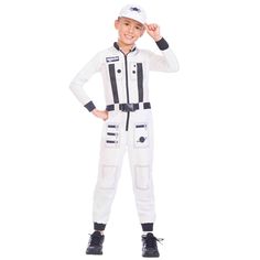 a young boy in a white space suit with black trimmings and an astronaut cap