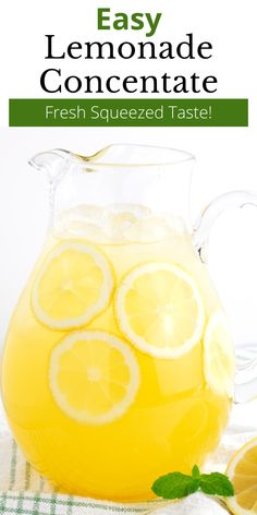 a pitcher filled with lemonade sitting on top of a table