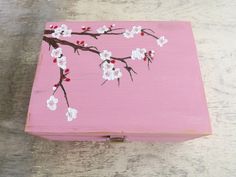 a pink box with white flowers painted on it