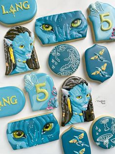 cookies decorated to look like avatars with the number five on them and numbers in blue icing