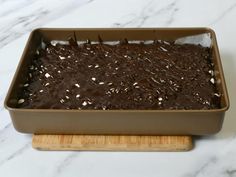 a chocolate cake in a pan on a cutting board