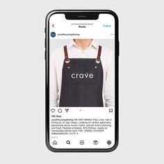 an iphone with the crave app on it's screen, and someone is wearing overalls