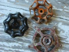 three different types of knobs sitting on top of a wooden table