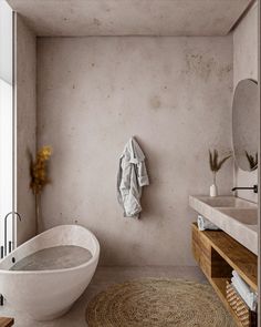 a bathroom with a bathtub, sink and rug in the floor next to it