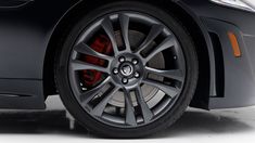 the front wheel of a black car on a white background