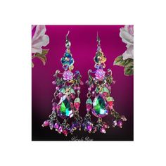 This pair of Handmade Chandelier Earrings is made with Vitrial Rose teardrop jewels and sparkly Blue helix crystal beads.  Fuchsia AB Czech glass roses and hand-wrapped bead charms add loads of colorful detail. They're a delicate fantasy design with a pretty sparkle! The teardrop jewels are a vibrant Mint Green with Magenta edging.  Pierced with french wires  clip-ons or posts, just select from the pull-down menu.  Choose from the long or short version.  The short is seen in the first 2 images.   Long Version: -4" Long x 1" Wide -0.3 oz. ea. Short Version: -2 3/4" x 1" -0.2 oz ea Metal Finishes Available: -Bronze (as pictured) -Silver Kerala Rose Pinterest page: https://www.pinterest.com/keralarose3/pins/ To re-enter my shop, Kerala Rose:  https://www.etsy.com/shop/kerala Jeweled Dangle Chandelier Earrings, Crystal Dangle Chandelier Earrings For Celebration, Crystal Chandelier Dangle Earrings For Celebration, Jeweled Dangle Chandelier Earrings As Gift, Jeweled Chandelier Dangle Earrings For Celebration, Pink Jeweled Dangle Chandelier Earrings, Crystal Chandelier Earrings With Dangling Beads, Bohemian Jeweled Crystal Dangle Earrings, Bohemian Jeweled Dangle Chandelier Earrings