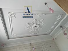 the ceiling is decorated with white and pink decorations