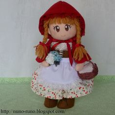 a little red riding hoodie doll holding a basket and flower in it's hand