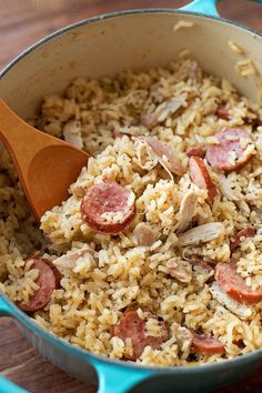 a blue pot filled with rice and sausage