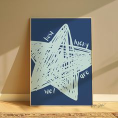 a blue and white star with the words lucky written on it is in front of a tan wall