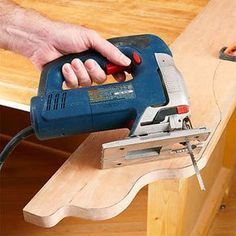 a person using a power tool on a piece of wood