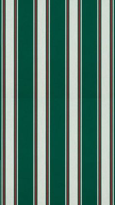 a green and white striped wallpaper with red, black, and white stripes on it