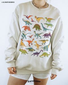 This Unisex crewneck sweatshirt features a colorful set of dinosaur illustrations. It is the perfect gift for dinosaur lovers, science teachers and present / future paleontologists! Make sure to check out the other garment options below :) » O P T I O N S « ‣ Tshirt: https://www.etsy.com/listing/1108948830 » A B O U T « ‣ This item is made to order using direct-to-garment (DTG) printing technology. This digital process involves the printer inks being jetted or sprayed onto the textile by a print Writer Academia, Dinosaur Species, Kawaii Grunge, Witch Sweatshirt, Grunge Clothing, Dinosaur Illustration, Goth Clothing, Dinosaur Gifts, Mens Cuts