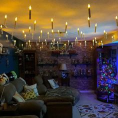 a living room filled with furniture and christmas lights