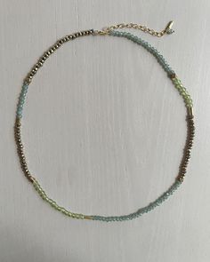 "Join my mailing list: http://eepurl.com/ci4wL and receive 10% off your next order! Find more of my jewelry on Instagram: Instagram: http://instagram.com/ruthiebeeeeee_jewelry Overview * Faceted tiny, peridot, green apatite, and gold pyrite necklace * Delicate, green, and gold beaded necklace * Hand strung with tiny gemstone beads and recycled brass accents * Adjustable necklace * Beads are 3mm * Finished with a gold filled spring clasp, a 2\" extender, and a tiny gemstone bead and recycled brass charm * Beads are strung on durable nylon thread Details * Necklace is available in  14-18\" lengths. Each necklace has a 2\" extender, making it adjustable. For example, the 16\" necklace can be worn up to 18\". * Model is 5'10\" with an athletic build. She's wearing the 16\" necklace. ›› ›› ›› › Pyrite Necklace, Sapphire Earrings Studs, Detailed Necklace, Sapphire Studs, Gold Bead Necklace, Brass Charms, Adjustable Necklace, Gold Chain Necklace, Beach Jewelry