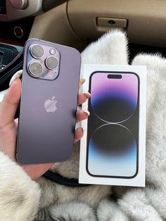 a person holding an iphone in their hand next to a box with the same product on it