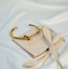 "This beautiful 18K Gold Plated aesthetic Minimalistic Open Design  Knot Cuff Bracelet is crafted with care and love. Its dainty and minimalistic style is great everyday wear or special occasion. It also makes a perfect gift for a wife, girlfriend, sister, mom or yourself! You can also get both colors to be matching with your loved one. 💌Specifications - Material: Gold Plated - Perfect for daily wear or special occasion - Durable, anti tarnish and high quality 🔨Processing Time: Please allow 1-2 days before the item ships out. 📦Shipping Time: Please select the USPS shipping option that suits you best at checkout. Enjoy Free Shipping on the orders of 35$ and up. 🎁Gift Wrapping: We will wrap the order pretty and ready for you in a gift box and can also hand write your personalized notes. Chic Handmade Bracelets As Gift, Minimalist Adjustable Cuff Bracelet As Gift, Adjustable Minimalist Cuff Bracelet For Gift, Minimalist Metal Bracelet For Gift, Gold Bracelets For Bridesmaids, Minimalist Metal Bracelets For Gifts, Minimalist Metal Bracelets As Gift, Elegant Bangle Cuff Bracelet For Bridesmaids, Chic Adjustable Bracelet As A Gift