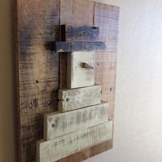 a piece of wood that has been made into a wall hanging on the side of a wall