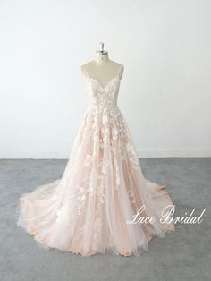 a pink wedding dress with white flowers on it