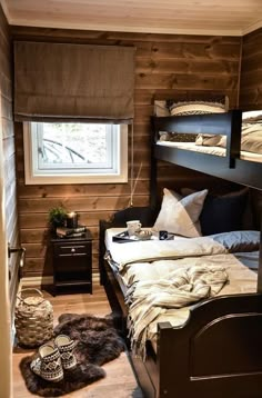 a bedroom with bunk beds and pillows on top of the bed in front of a window