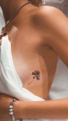 a woman with a rose tattoo on her chest