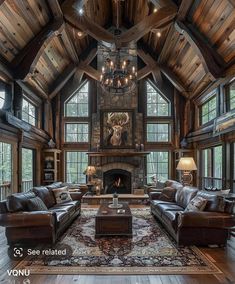 a living room with couches, chairs and a fire place in the middle of it