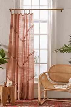 a living room with a chair, rug and window