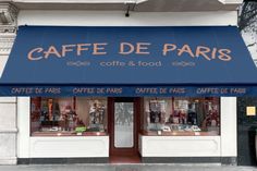 a coffee shop with blue awnings on the side of it's building