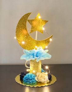 a cake that has been decorated with gold stars and a moon on top of it