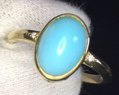 Genuine blue turquoise set in 18k yellow gold.  Natural diamond accents are set around and on the side. Specifications: 18k Gold Genuine Turquoise Natural Diamond Accents Ring size 6.5 Elegant Yellow Gold Turquoise Cabochon Ring, Luxury Yellow Gold Turquoise Ring For Formal Occasions, Heirloom Yellow Gold Turquoise Ring For Formal Occasions, 14k Gold Blue Oval Cabochon Turquoise Ring, Blue Turquoise 14k Gold Oval Cabochon Ring, Blue Turquoise Oval Cabochon Ring In 14k Gold, Elegant Gold Turquoise Ring With Bezel Setting, Blue Oval Cabochon Turquoise Ring In 14k Gold, Formal 14k Gold Turquoise Blue Ring