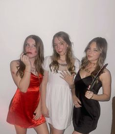 three girls in dresses posing for the camera